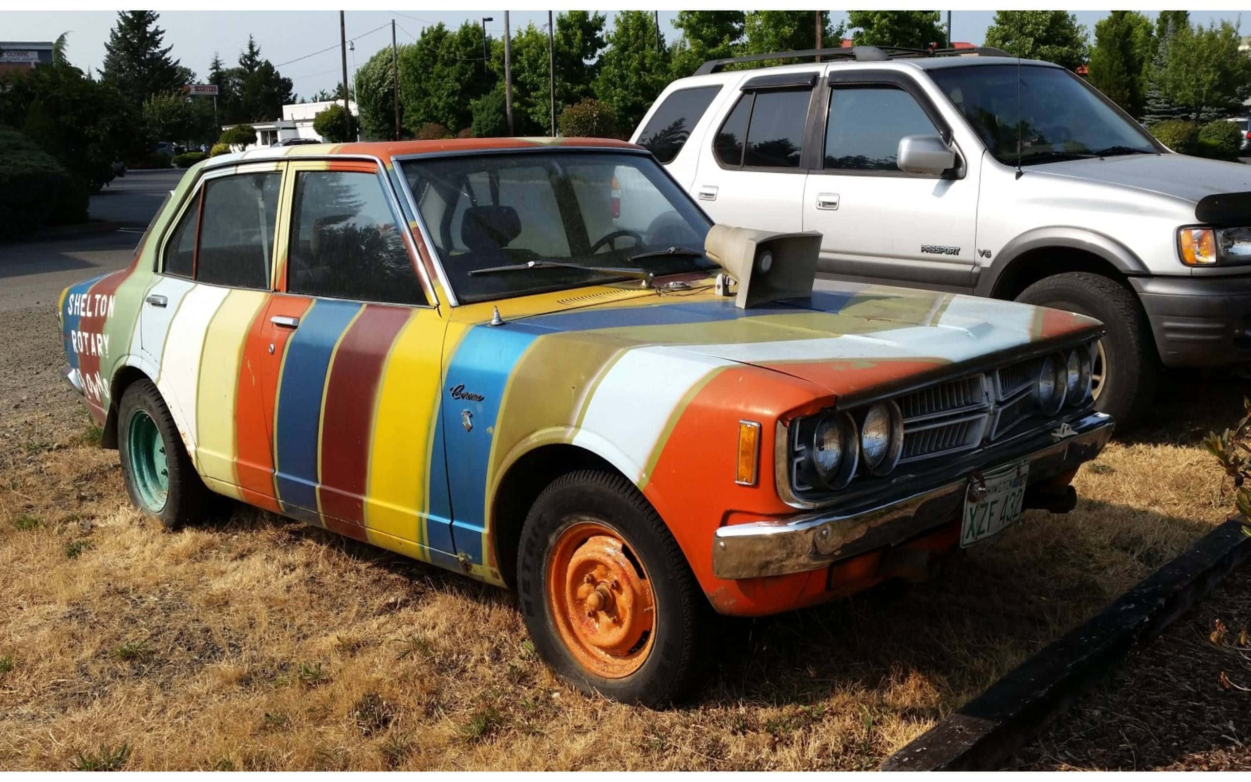Multicolored Vintage Car Parked Outdoors.jpg