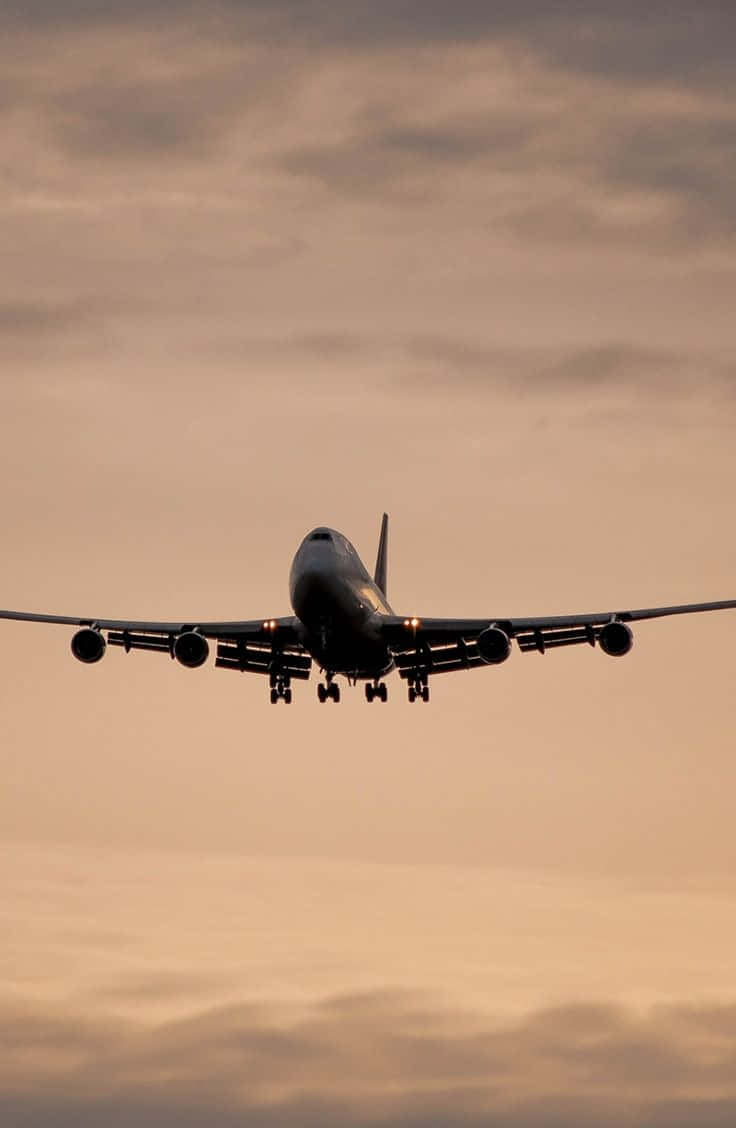 A 747 Airplane Illuminated By Beautiful Lighting Wallpaper