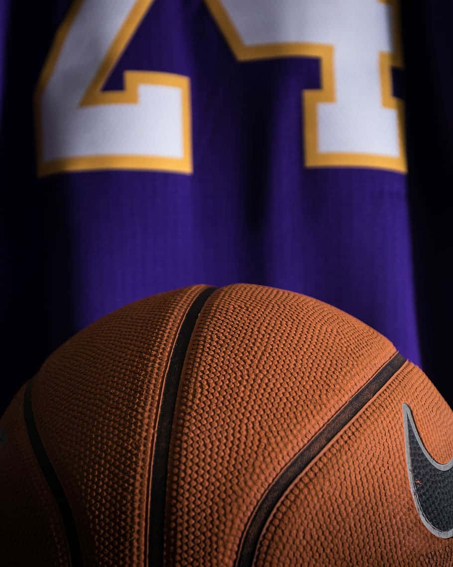 A Basketball Is Sitting On A Purple Jersey Wallpaper