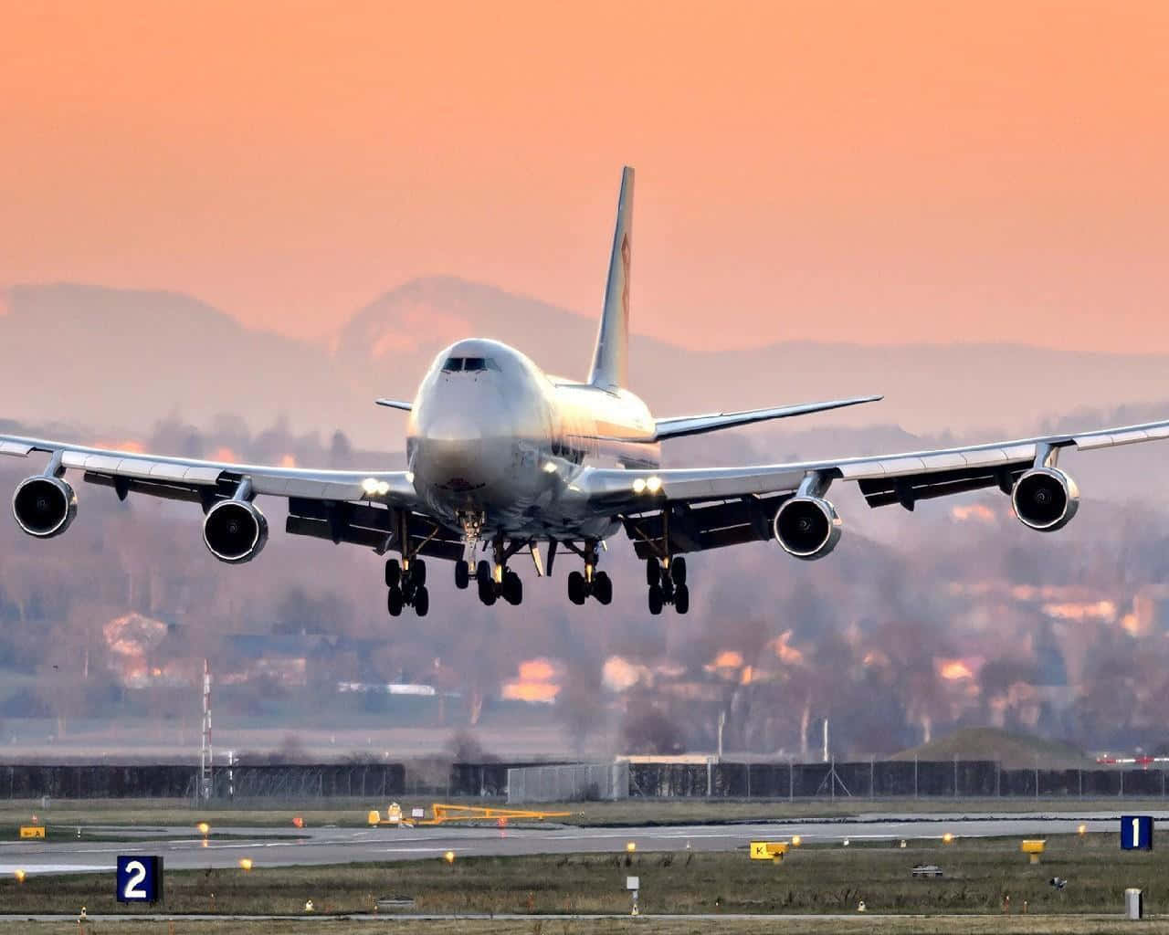 'a Boeing 747 Airplane Taking Off Against A Blue Sky' Wallpaper