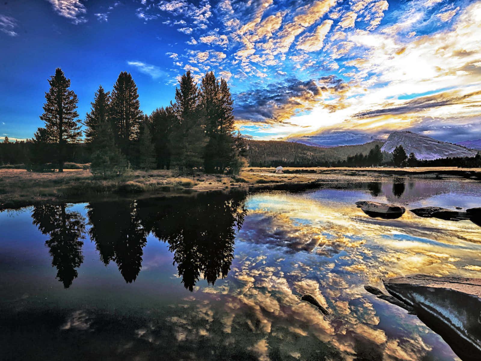 A Colorful Landscape Of A Lake Surrounded By Mountains Wallpaper