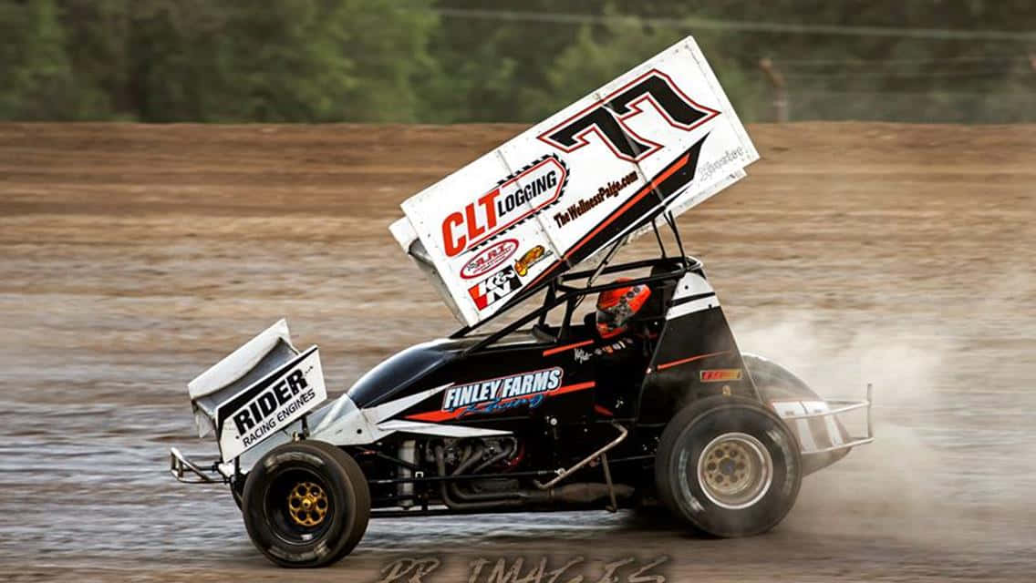 A Dirt Track Race Car Driving Through A Muddy Field Wallpaper