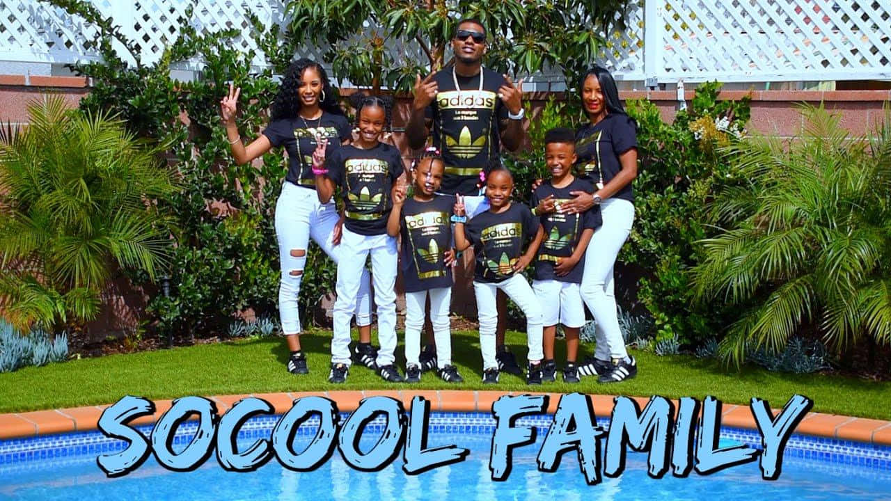 A Family Posing In Front Of A Pool Wallpaper