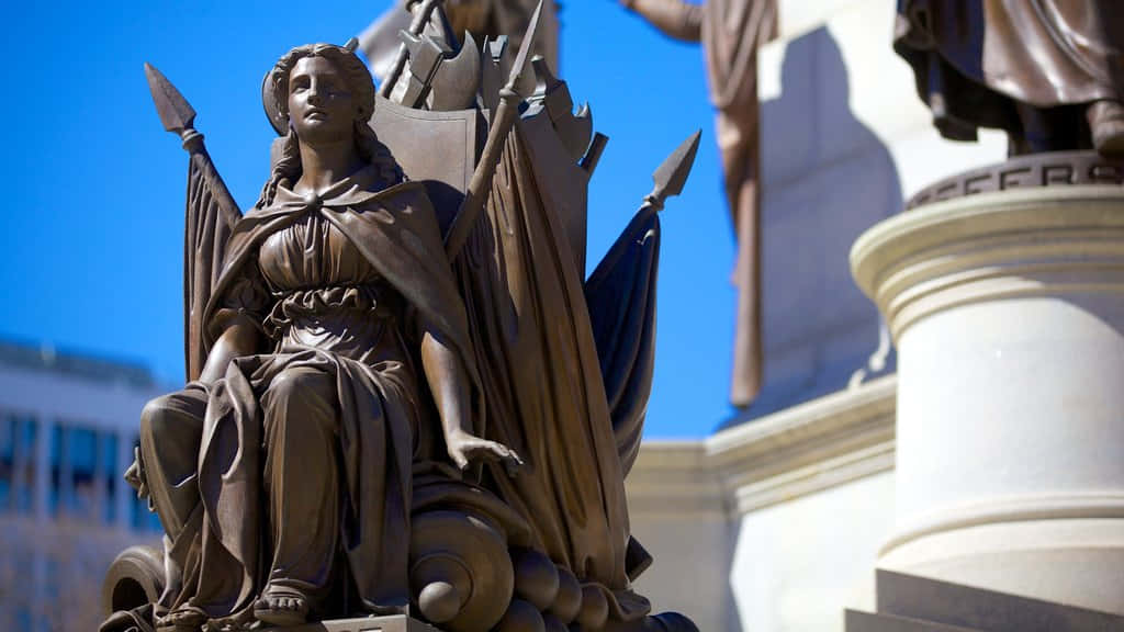 A Female Bronze Statue At The Virginia State Capitol Wallpaper