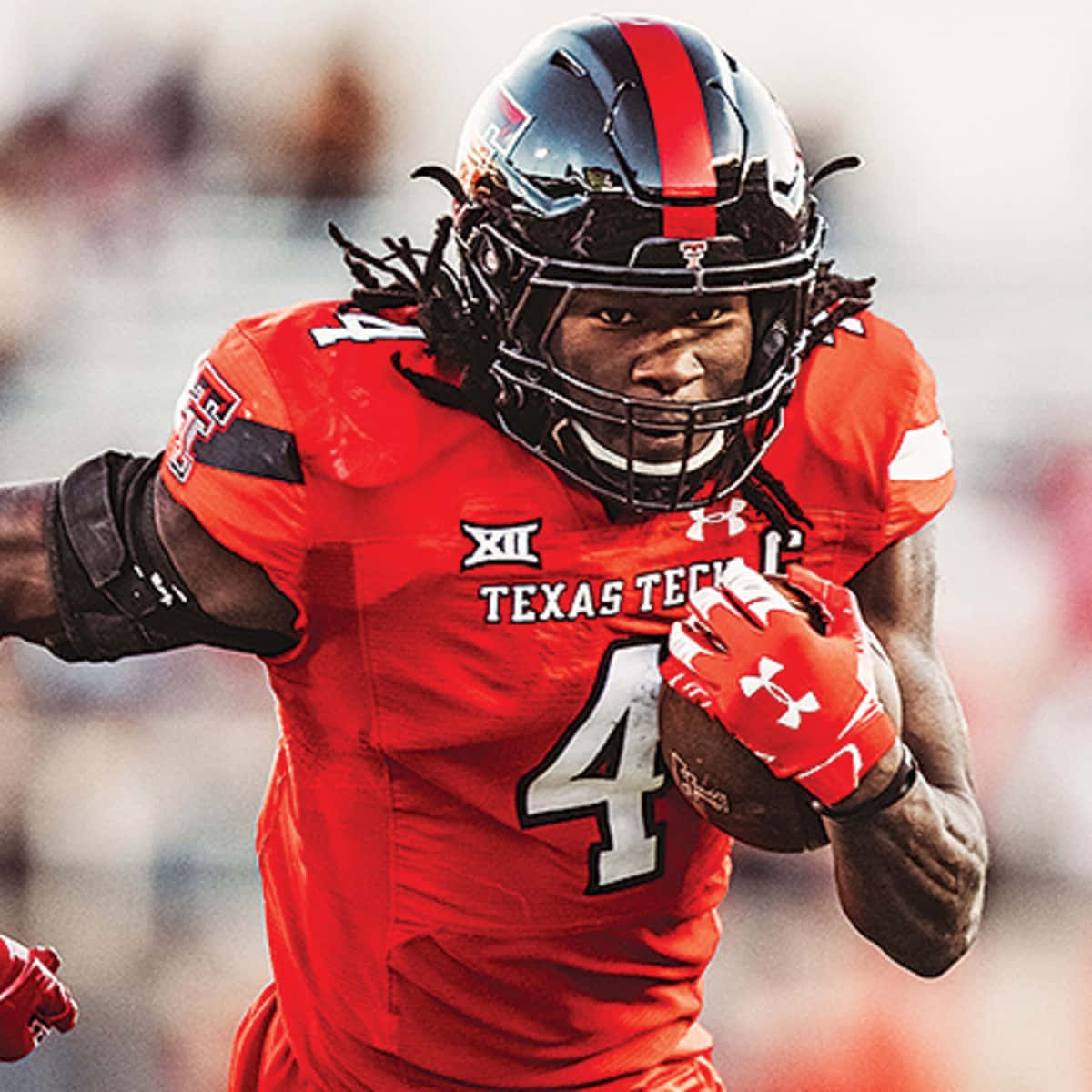 A Football Player Running With A Ball Wallpaper