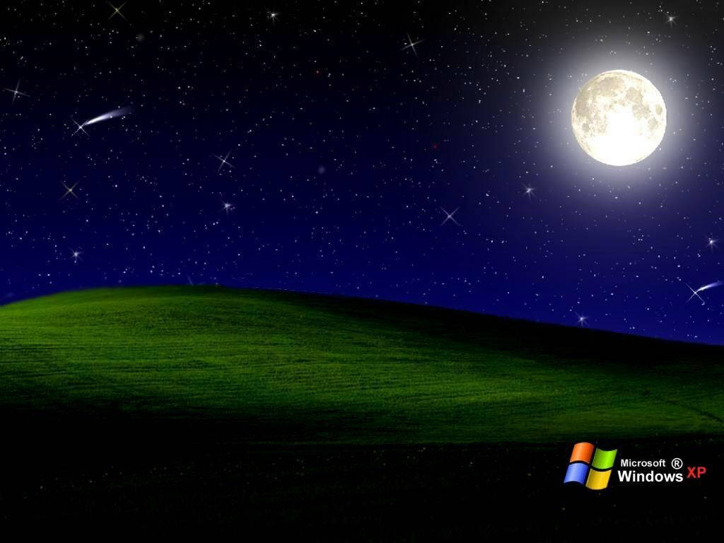 A Full Moon Is Seen Over A Green Field Wallpaper