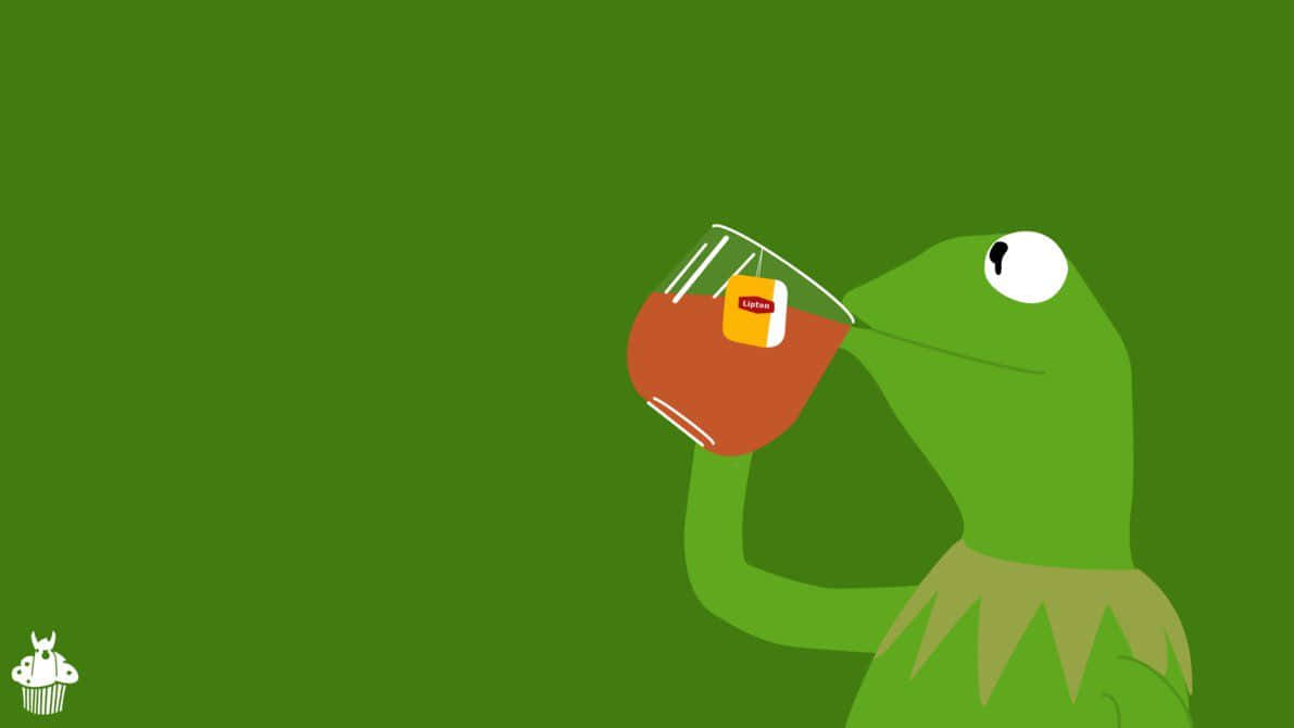 A Green Frog Drinking A Cup Of Tea Wallpaper