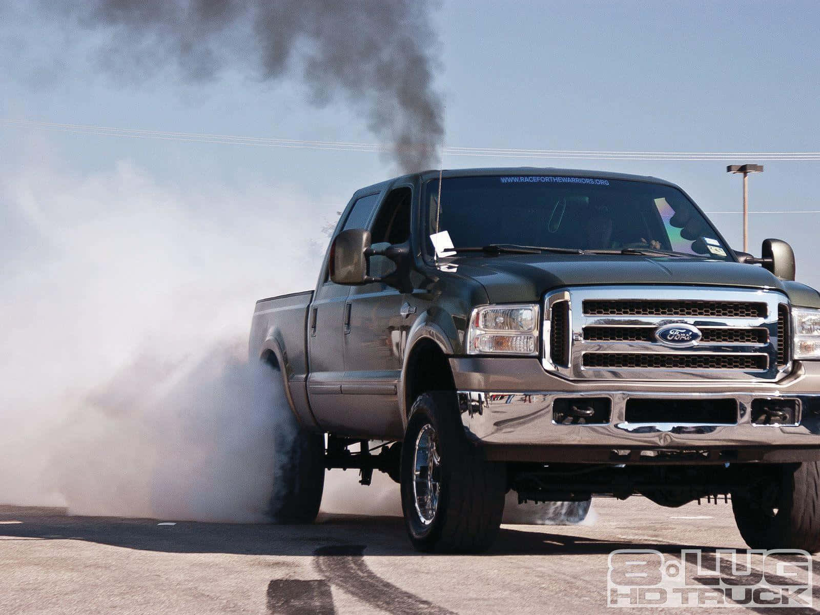 A Green Truck With Smoke Coming Out Of It Wallpaper