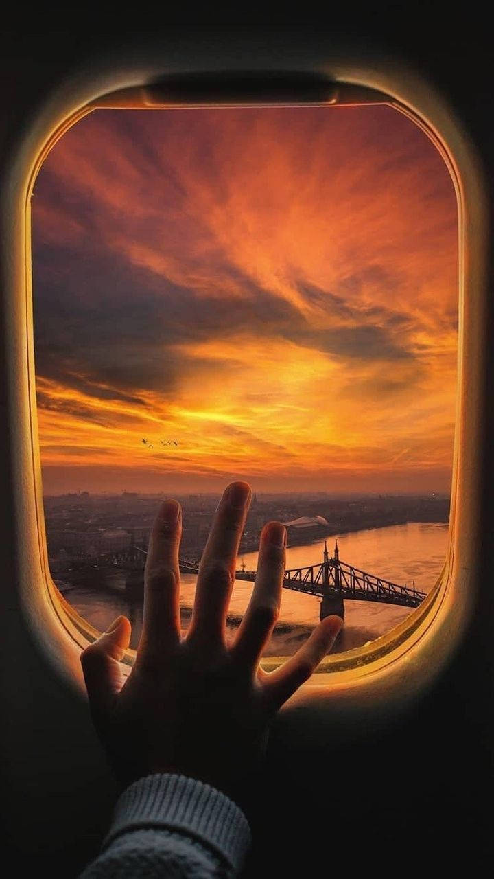 A Hand On A Plane Window Wallpaper