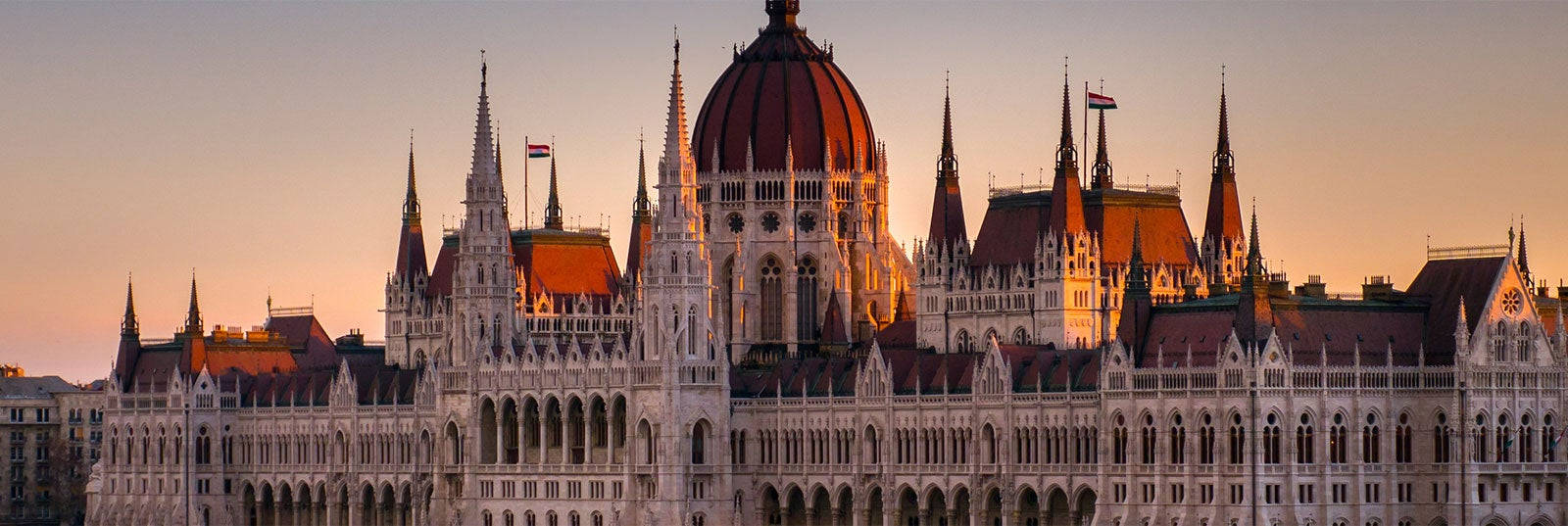 A Large Building With A Clock Tower In The Background Wallpaper