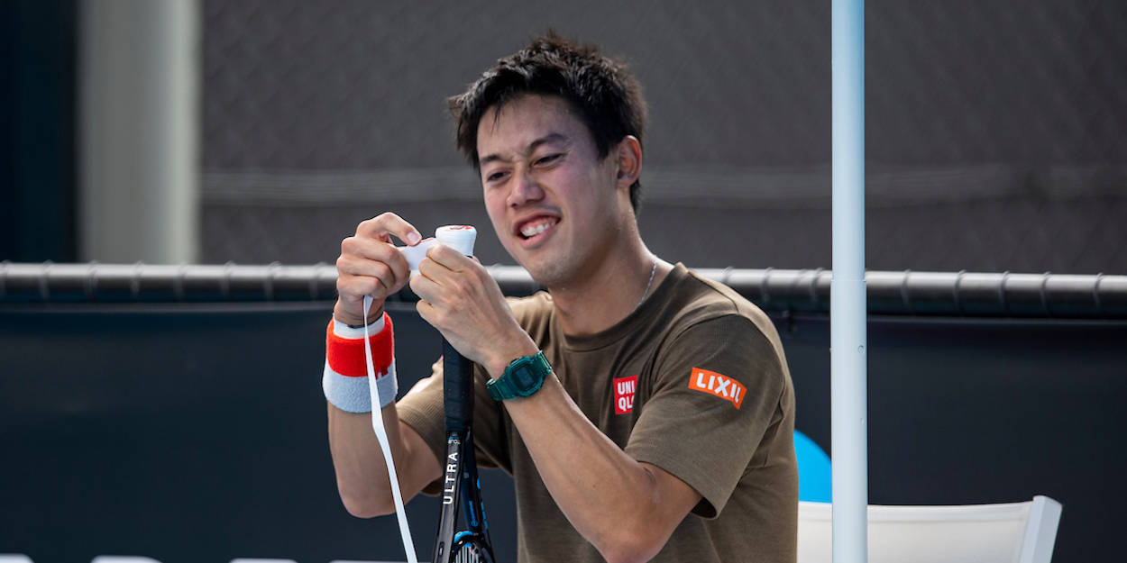 A Man Is Holding A Tennis Racket Wallpaper