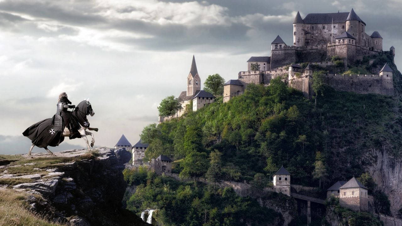 A Man Riding A Horse On A Cliff Near A Castle Wallpaper