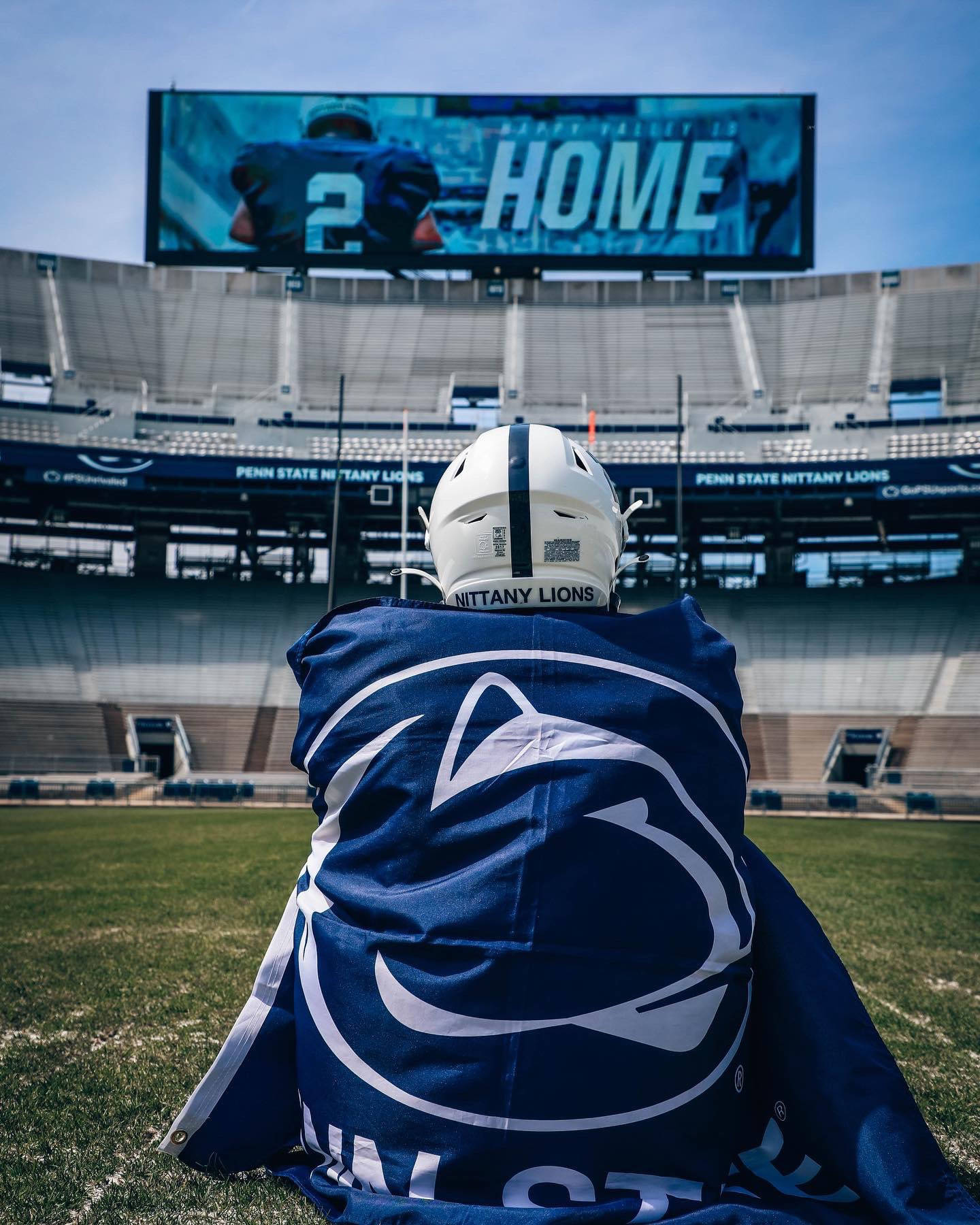 A Man Sitting On The Field With A Blanket Wallpaper