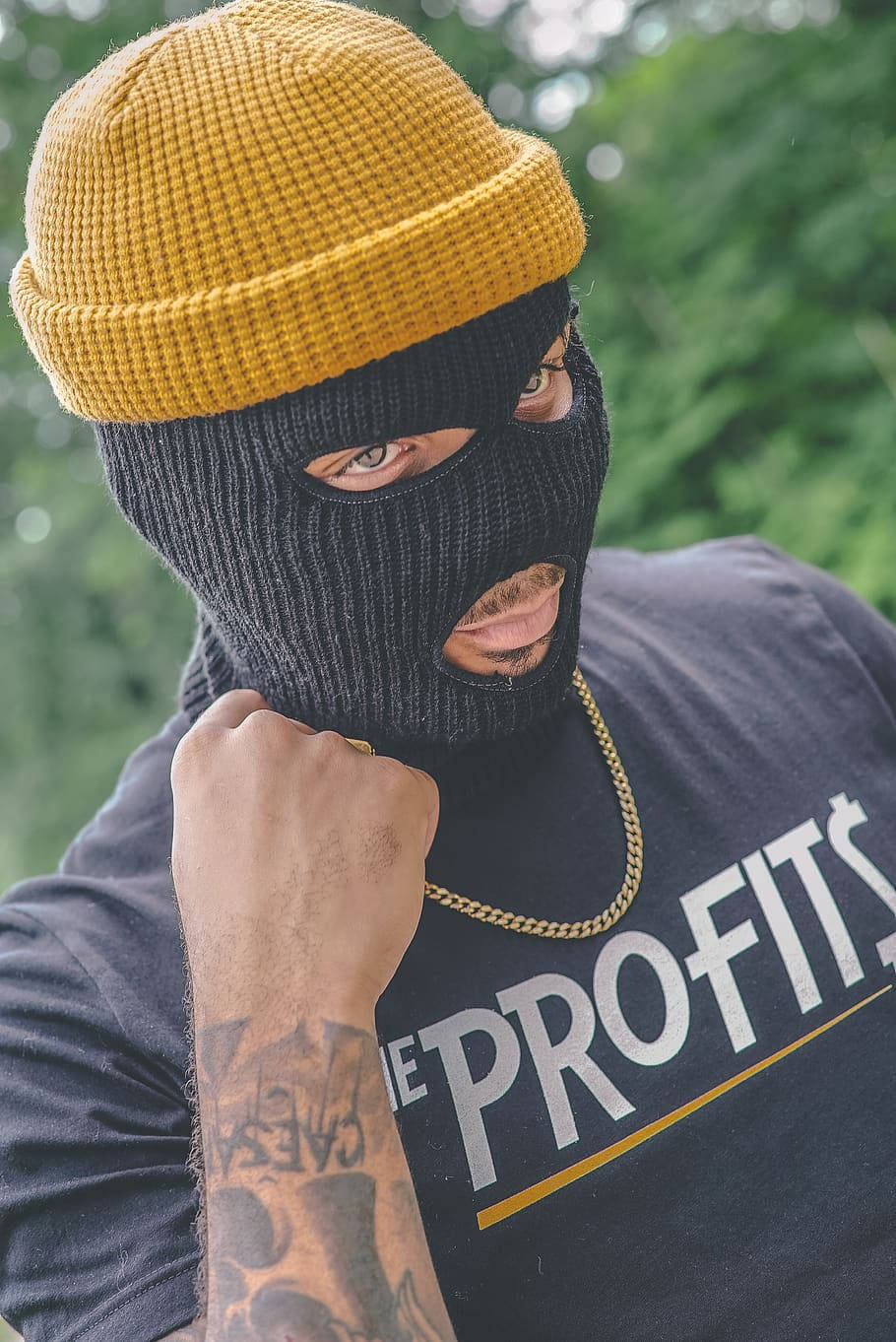 A Man Wearing A Black Mask And Yellow T - Shirt Wallpaper