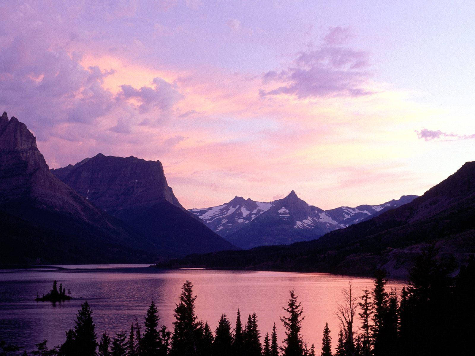 A Mountain Range Is Seen In The Distance Wallpaper