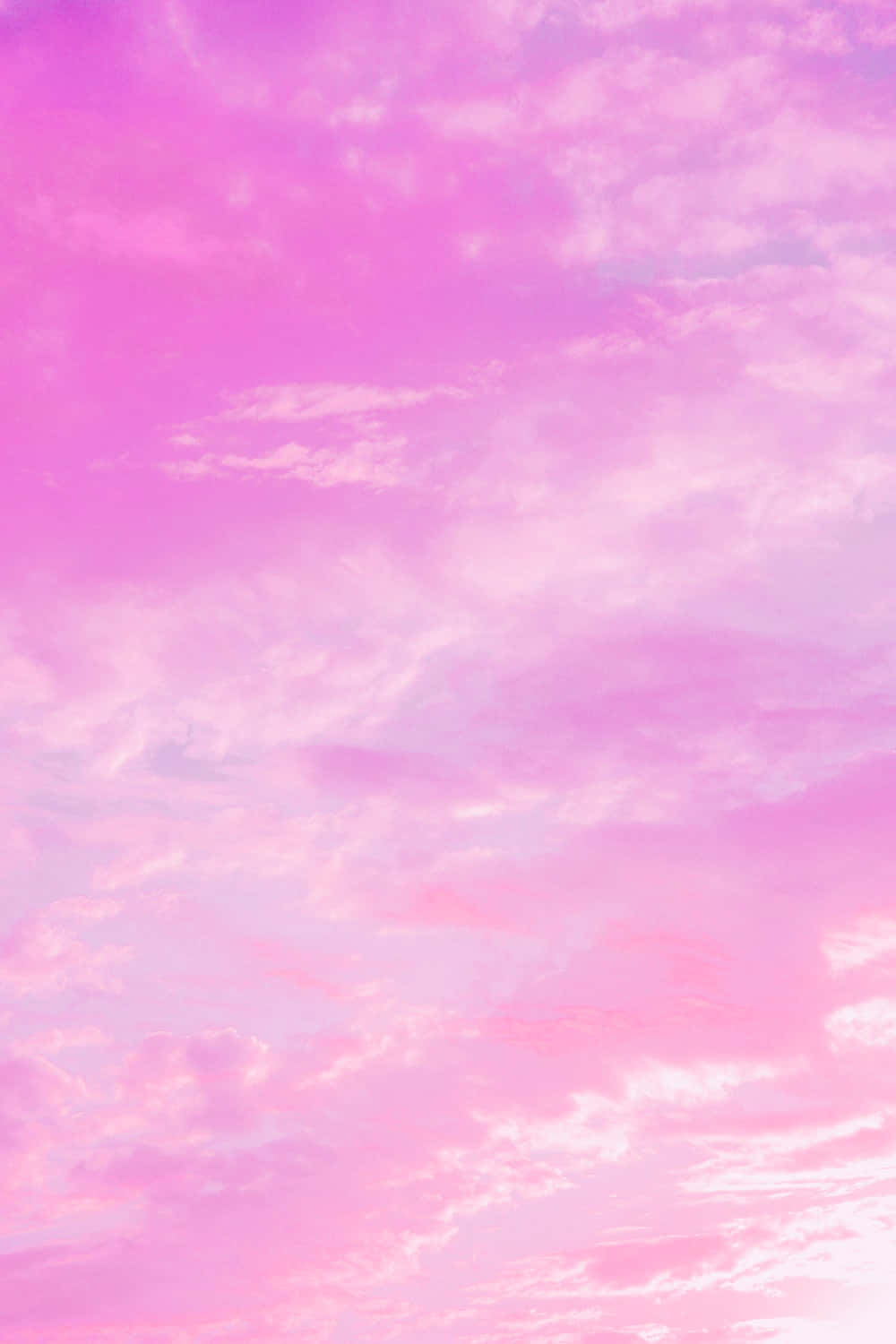 A Pink Sky With Clouds In The Background Wallpaper