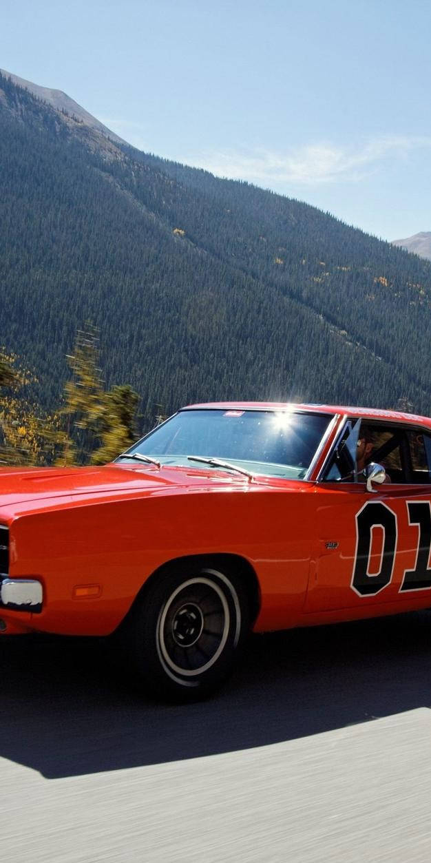 A Red And Orange Car Driving Down A Road Wallpaper