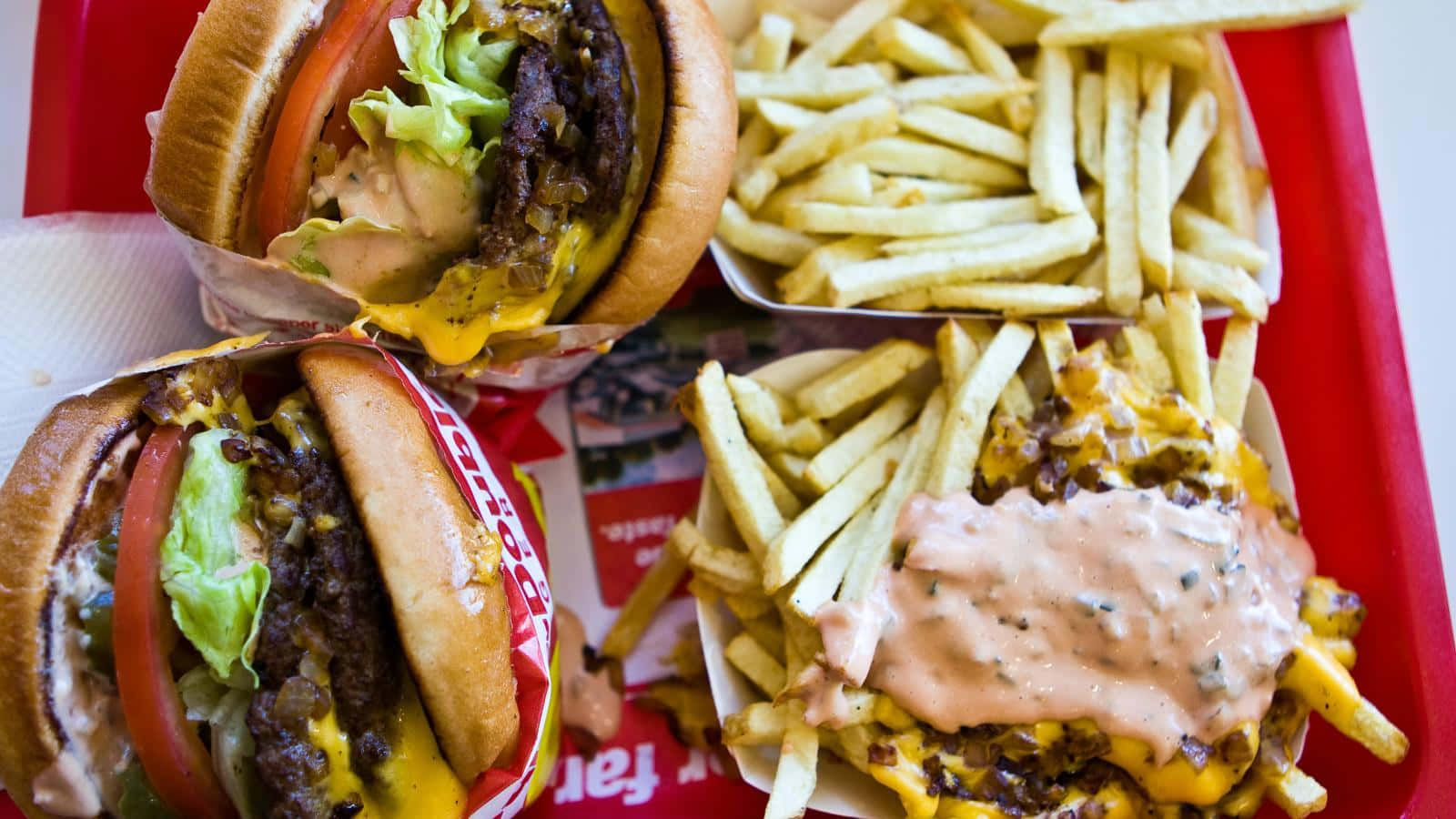 A Red Tray With Two Hamburgers And Fries Wallpaper