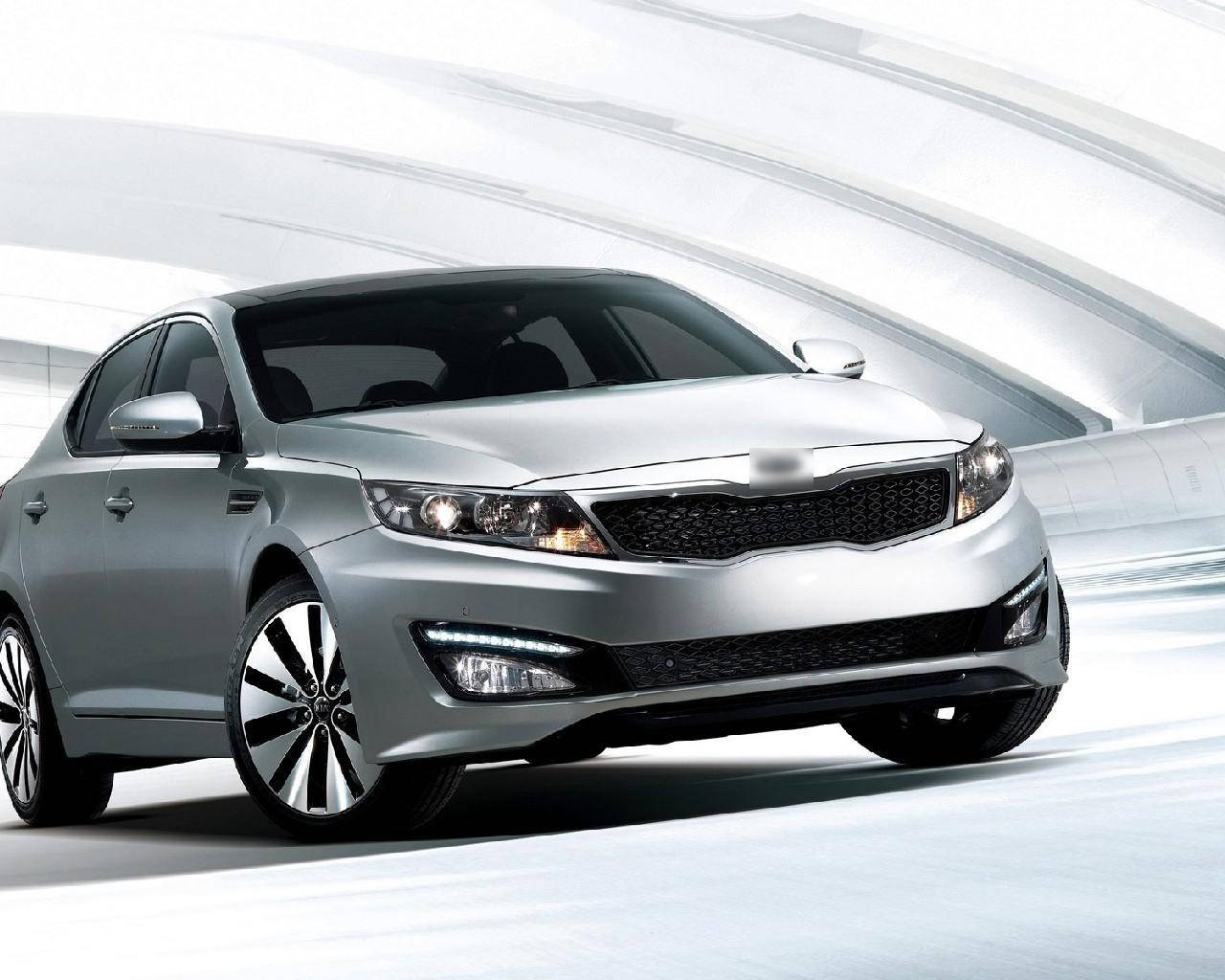 A Sleek Kia Optima Stands At The Ready Wallpaper