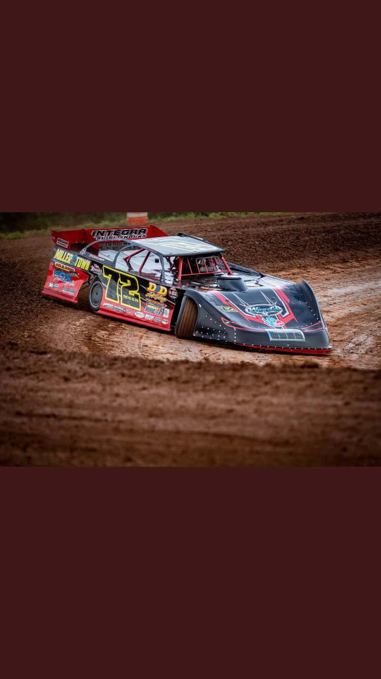 A Sprint Car Drifting Around The Track At High Speed Wallpaper