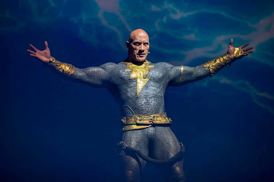 A Statue Of A Man In A Gold Suit Wallpaper
