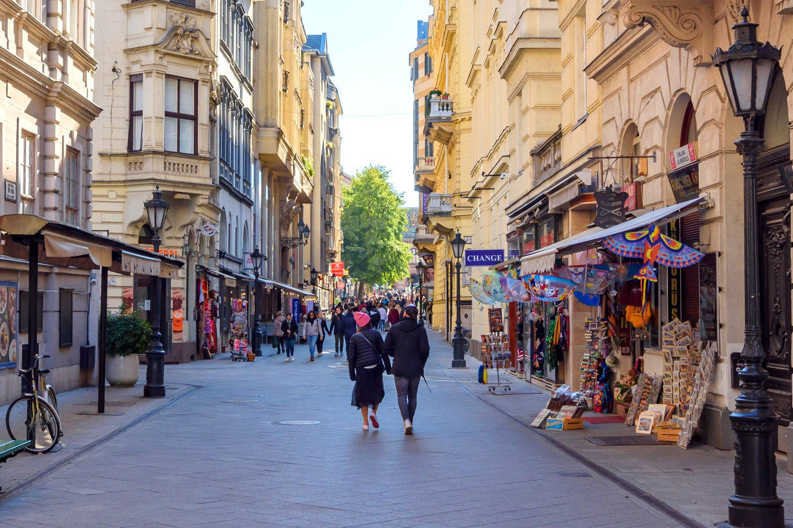 A Street With People Walking Down It Wallpaper