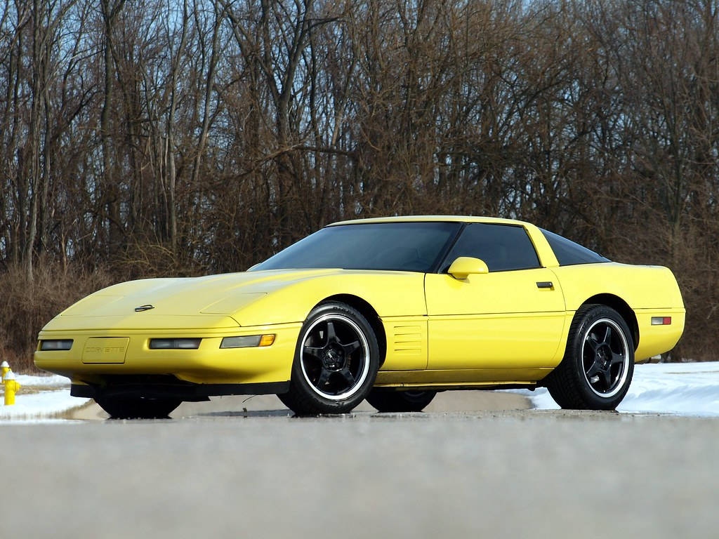 A Stunning Yellow C4 Corvette Graces The Winter Landscape Wallpaper