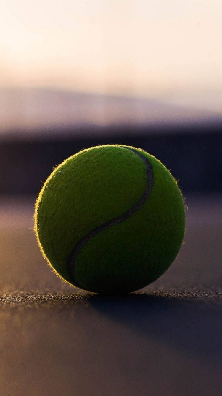 A Tennis Ball On A Tennis Court Wallpaper