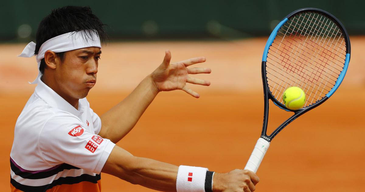 A Tennis Player Is Swinging His Racket At A Ball Wallpaper