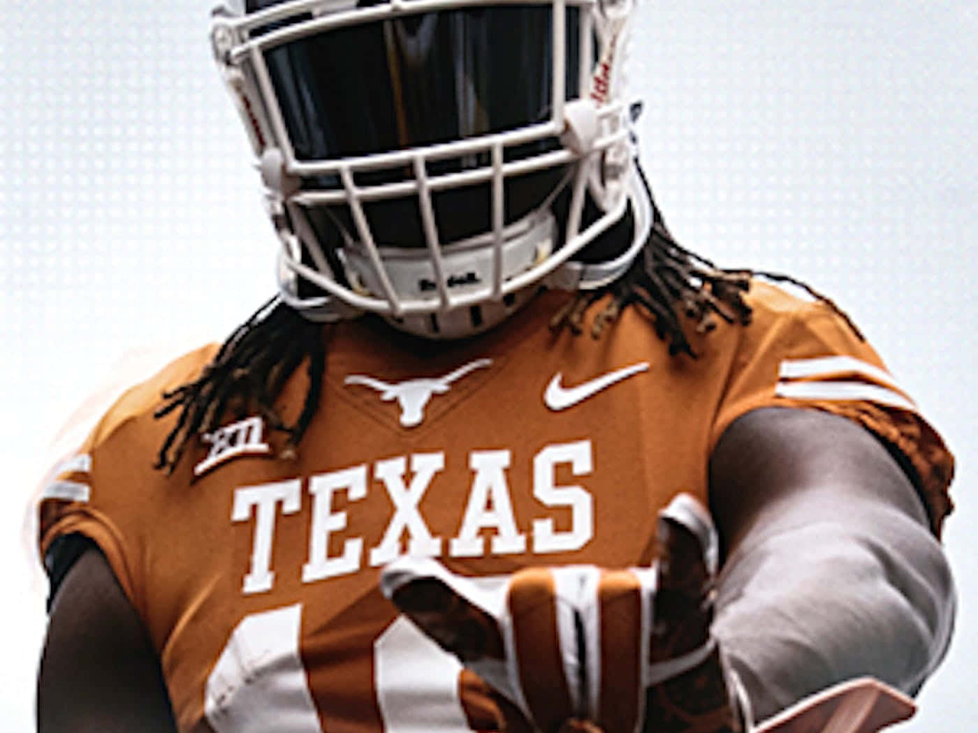 A Texas Football Player Is Holding A Football Wallpaper