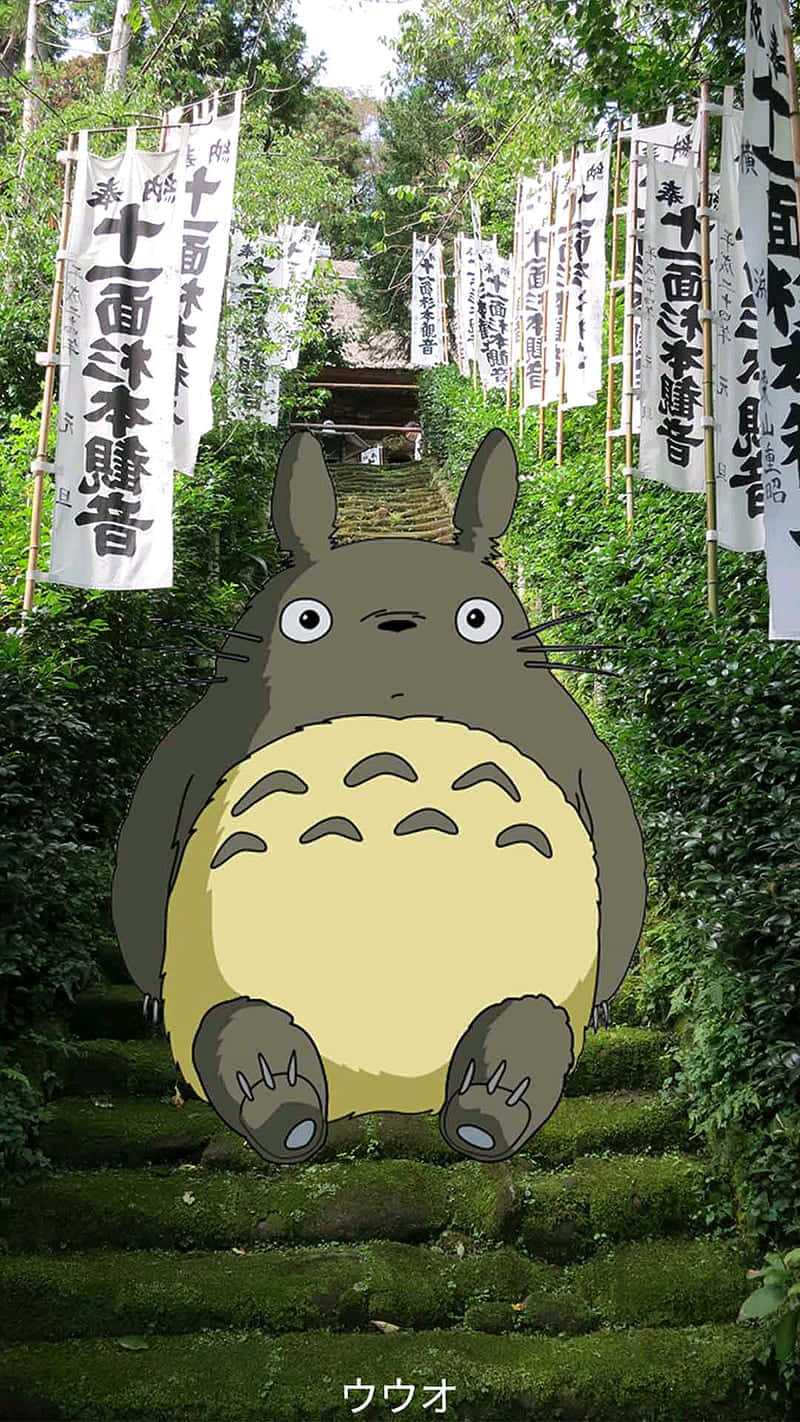 A Totoro Sitting On A Set Of Stairs Wallpaper