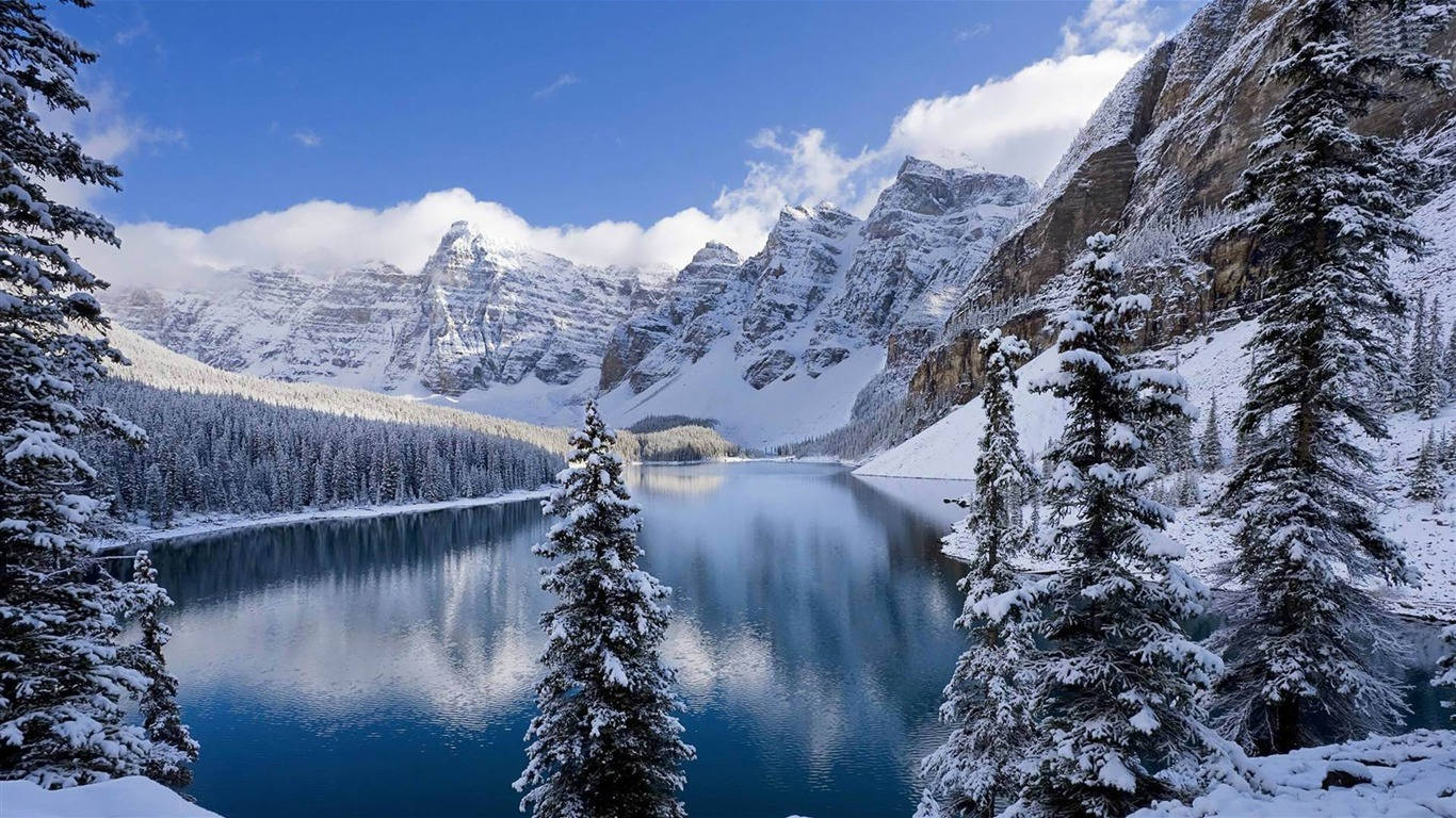 A View Of Beautiful Winter Scenery With Snow-covered Mountains And Trees Wallpaper