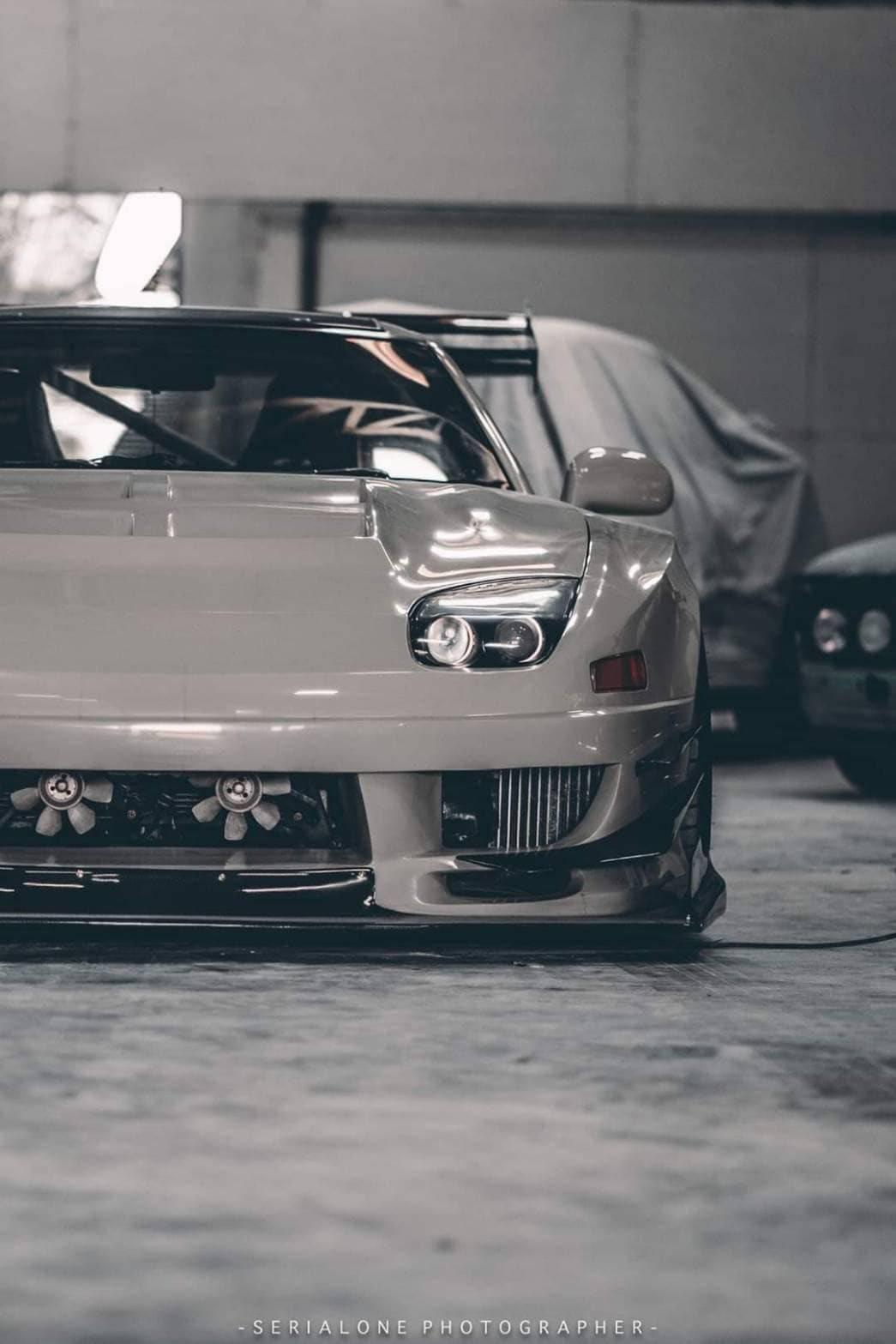 A White Sports Car Parked In A Garage Wallpaper