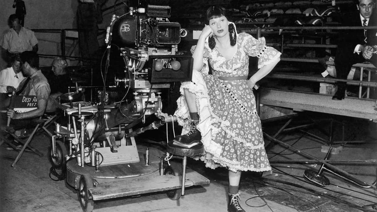 A Woman In A Dress Standing On A Set Wallpaper