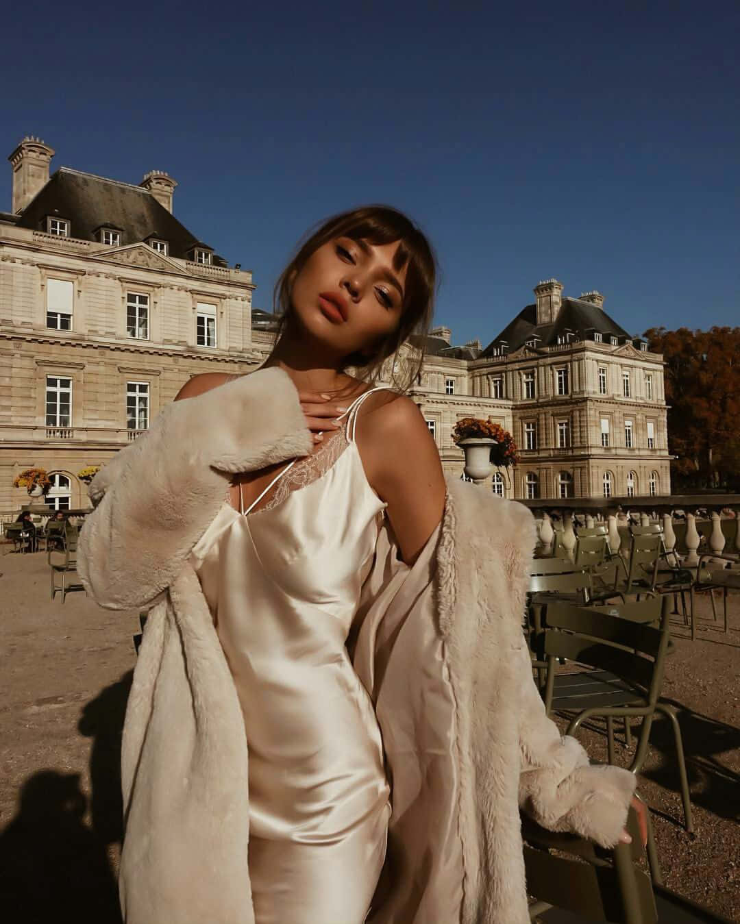 A Woman In A White Dress Posing Outside Wallpaper