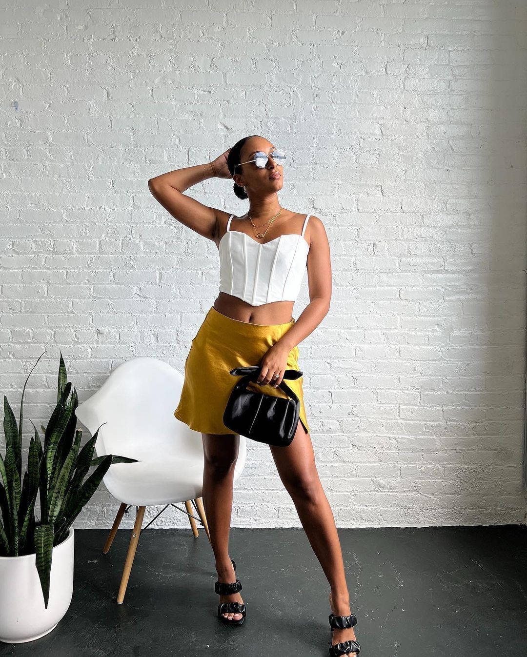 A Woman In A Yellow Skirt And White Top Wallpaper