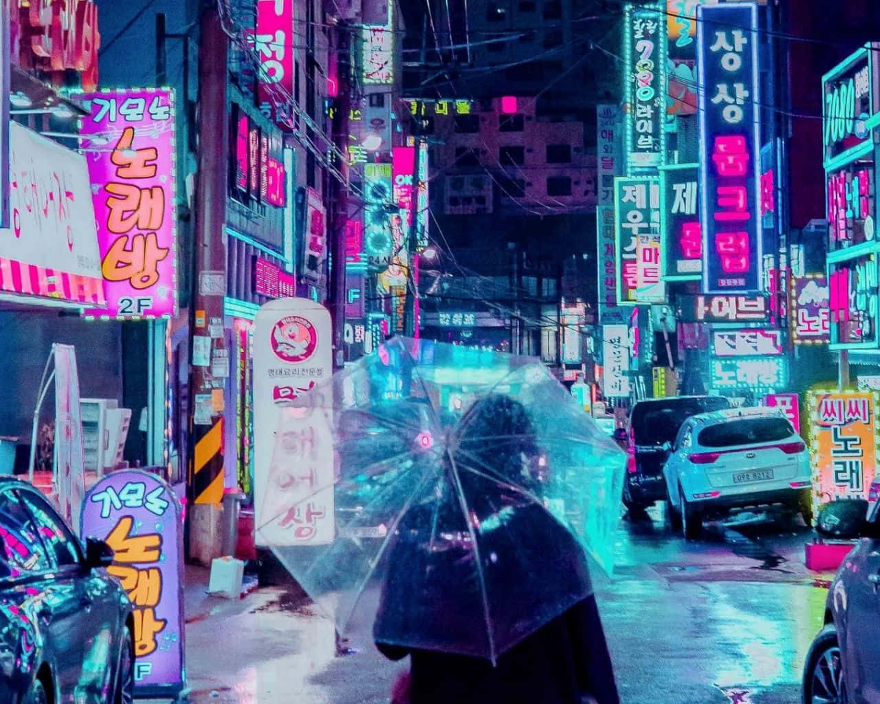 A Woman Walking Down A Street With Neon Signs Wallpaper