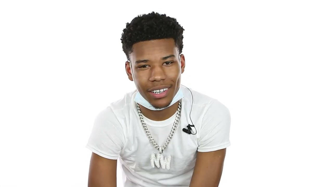 A Young Man Wearing A White Shirt And A Necklace Wallpaper