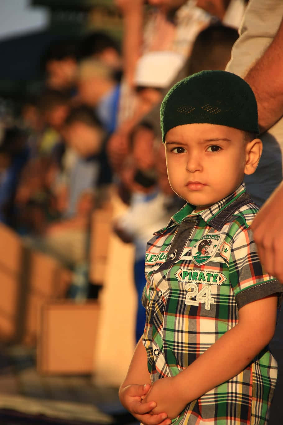 A Young Muslim Boy In A Contemporary Green Checkered Polo Wallpaper