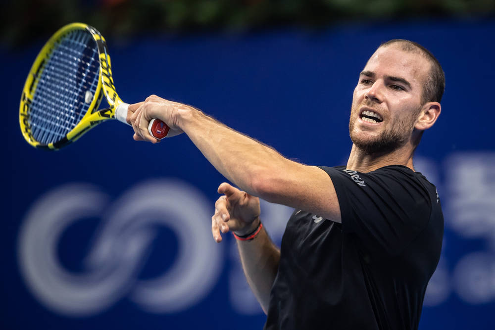 Adrian Mannarino Executing A Forehand Stroke In A Tennis Match. Wallpaper