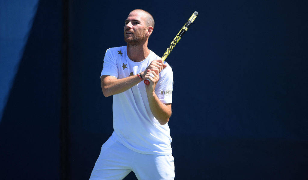 Adrian Mannarino In A Reflective Moment On Court Wallpaper