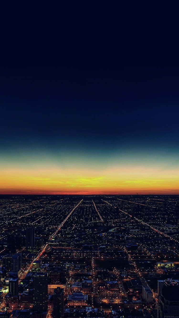 Aesthetic Sunset Iphone With Skyscrapers And City Lights Wallpaper
