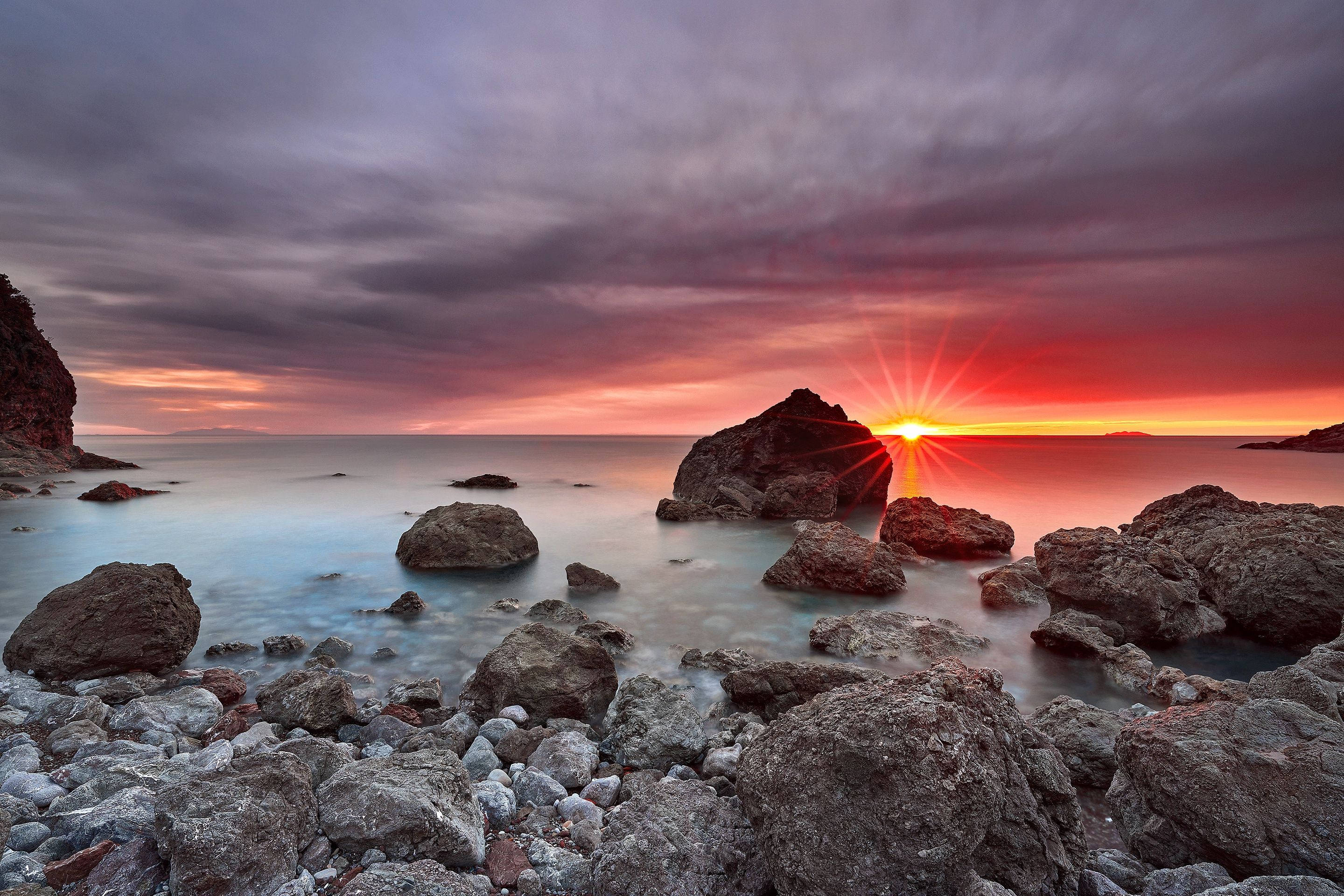 Aesthetic Sunset Over Rocky Ocean Wallpaper