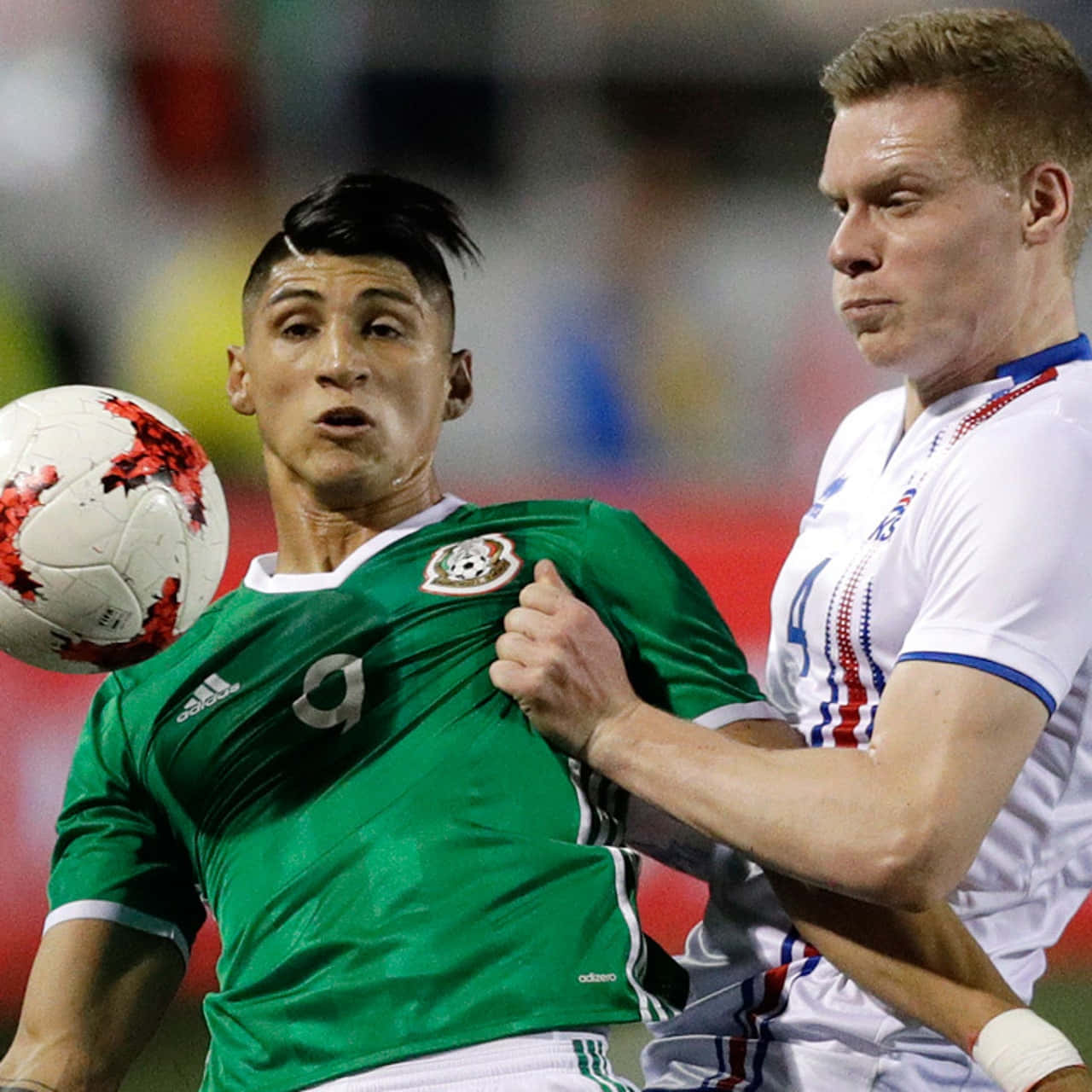 Alan Pulido Challenging The Spain Defender During An International Soccer Match Wallpaper