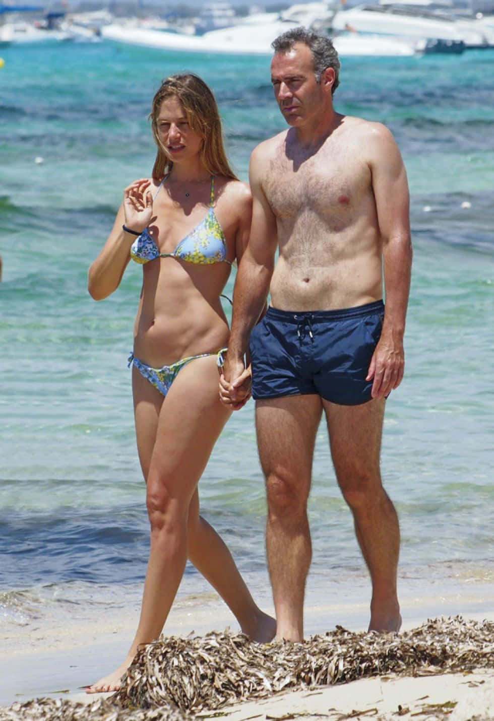 Alex Corretja And Wife Walking On Beach Wallpaper