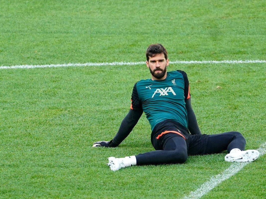 Alisson Becker Sitting On The Field Wallpaper