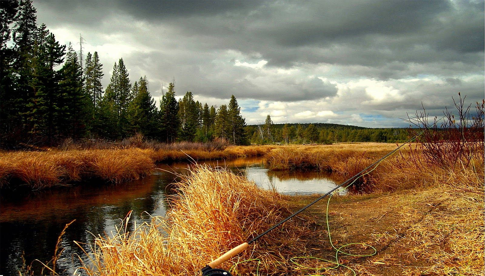 An Old-fashioned Wooden Fishing Rod For A Peaceful Day Of Fishing Near The River Wallpaper