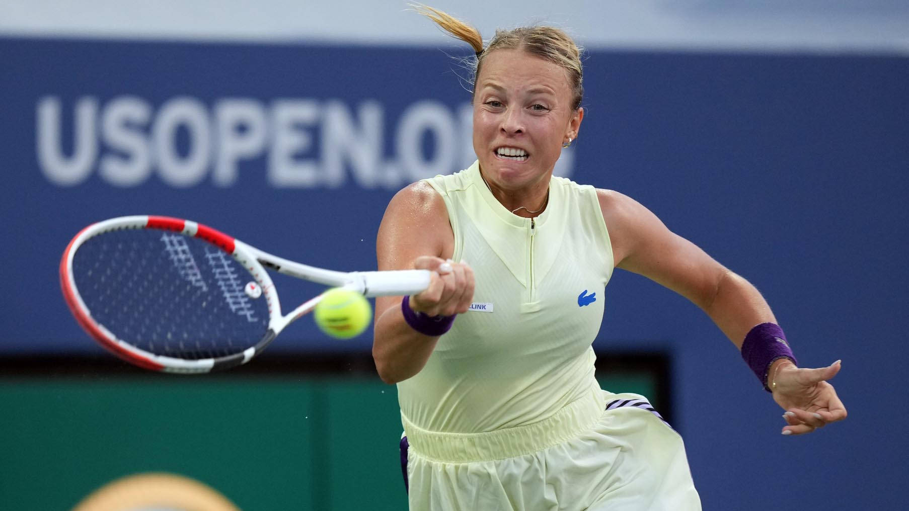 Anett Kontaveit In Yellow Striking Ball Wallpaper