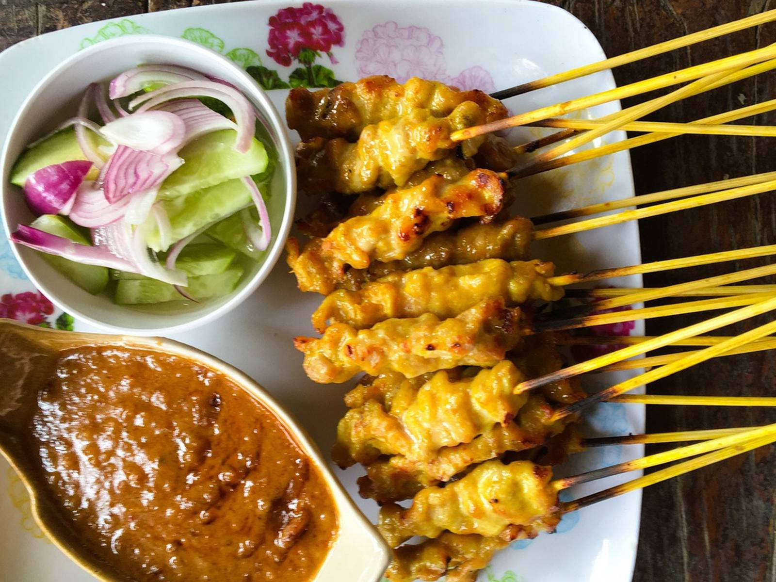 Asian Delight: A Scrumptious Plate Of Chicken Satay With Cucumber Salad Wallpaper