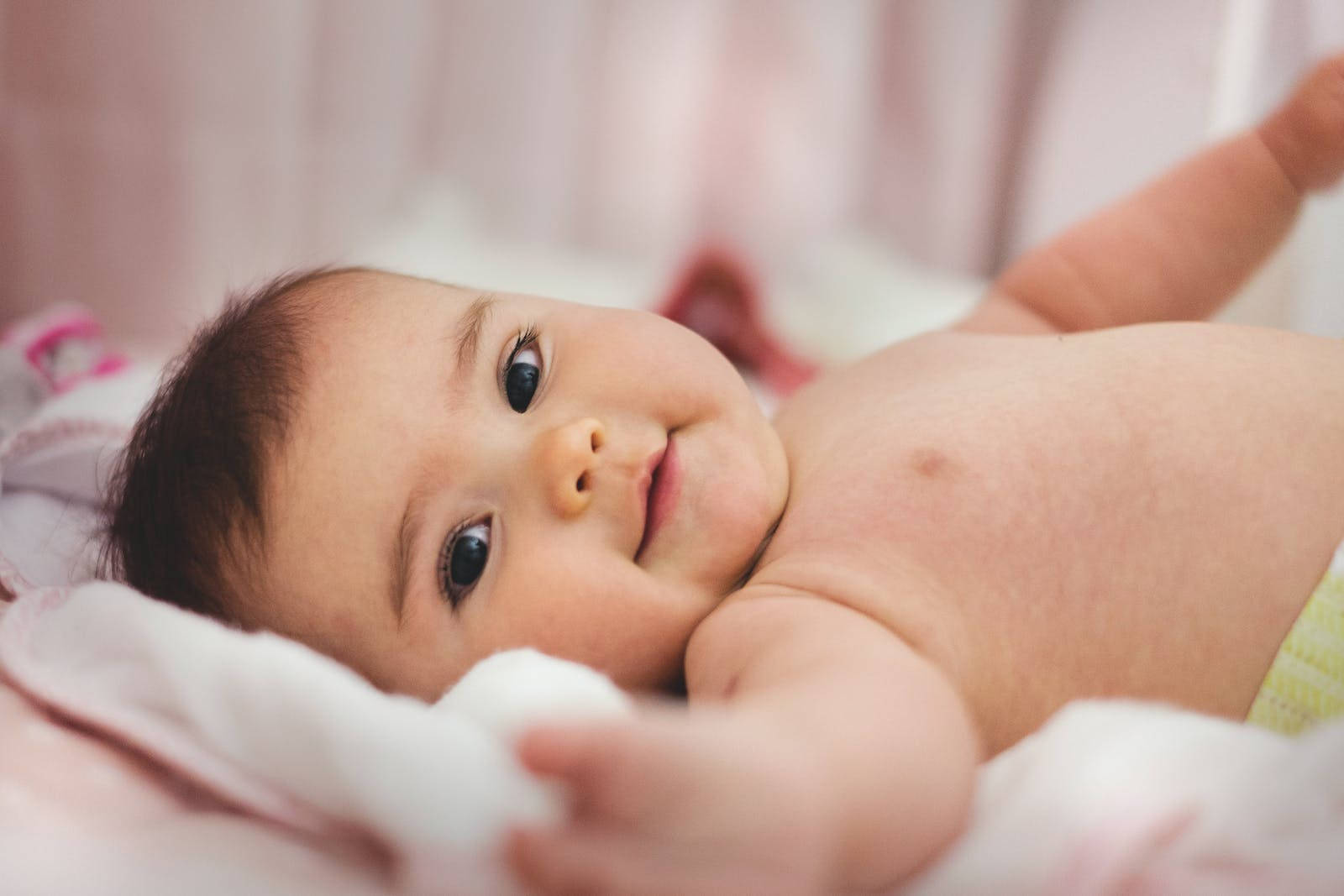 Baby Boy Laying On Bed Wallpaper